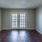 a living room with a wood floor and back doors