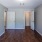 a bedroom with white doors and a wood floor