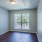 a room with a wood floor and a window